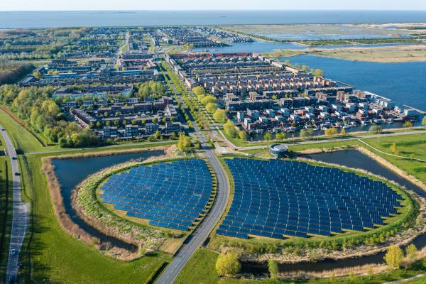 Aerial view of a modern sustainable neighbourhood in Almere, The Netherlands. The city heating (stadswarmte) in the district is partially powered by a solar panel island (Zoneiland). 